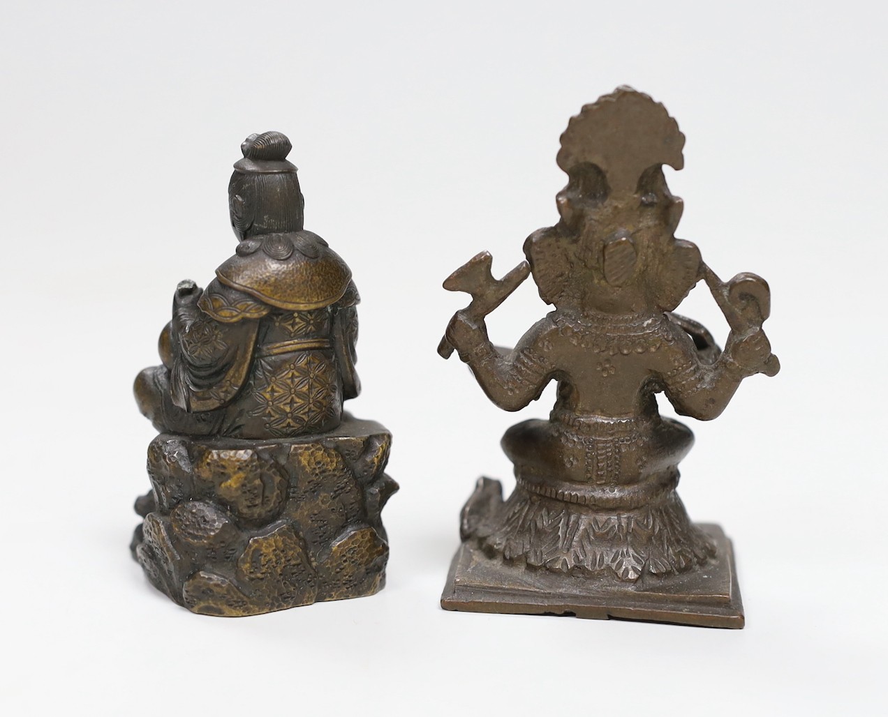 A Japanese Meiji period bronze of a seated figure, inscription to base together with an Indian bronze of Ganesh, tallest 8cms high